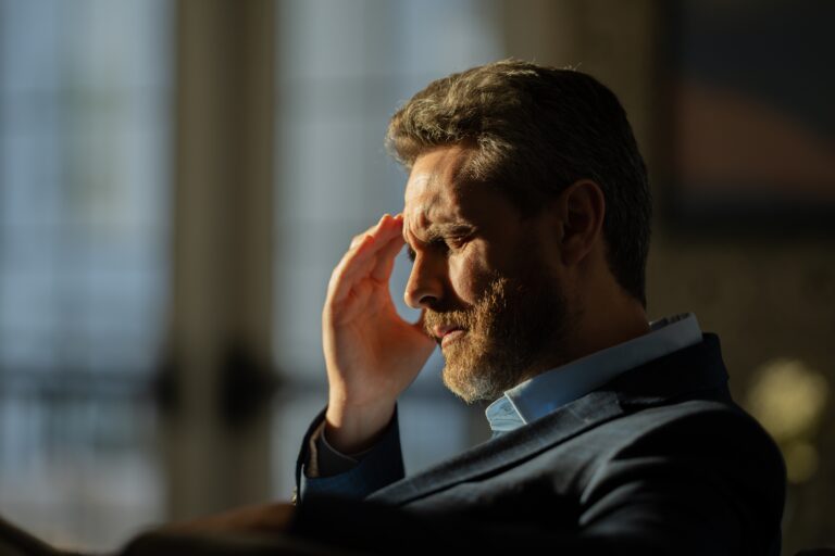 man suffering from a severe headache, possible TMJ